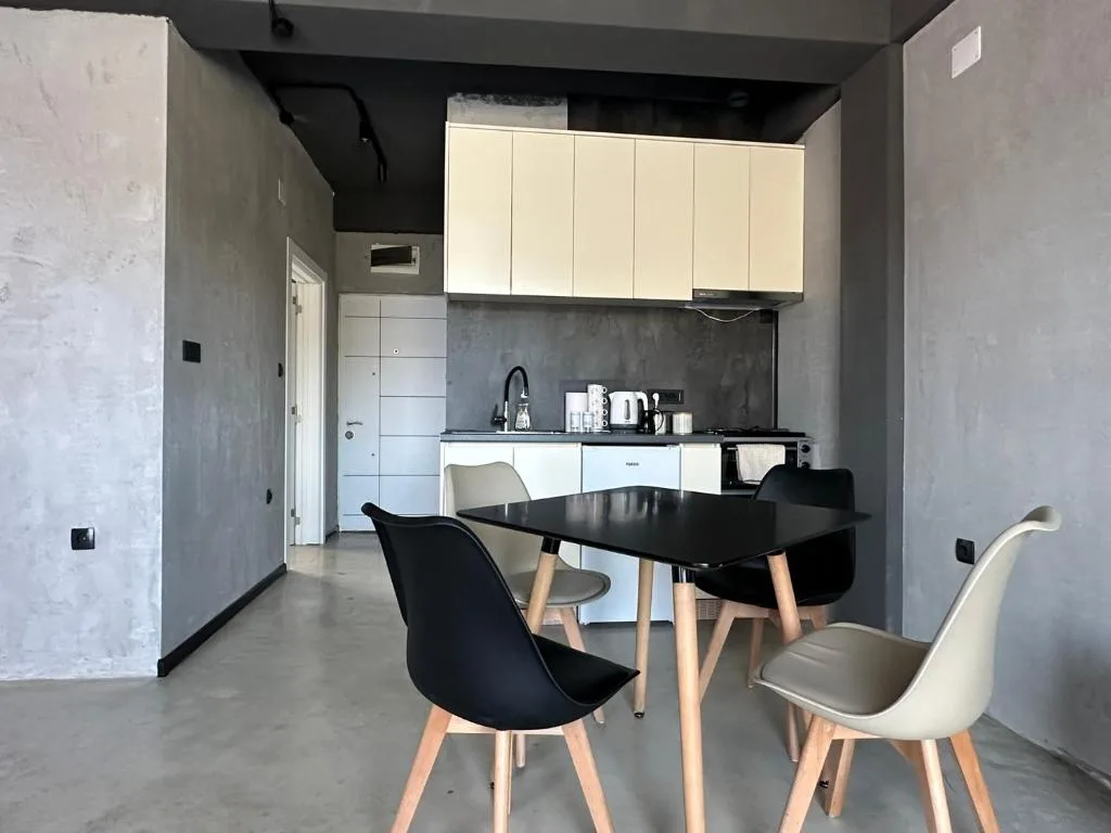Kitchenette with oven, refrigerator and dining table