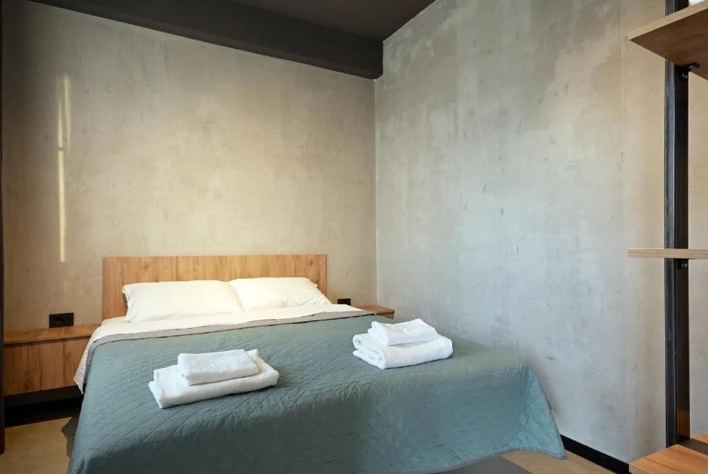 Studio bedroom with green headboard